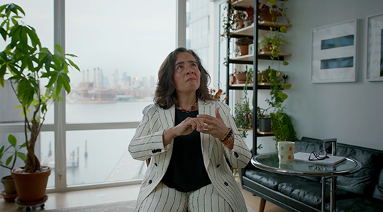 Dr Oxris Barbot wearing a white pinstripe suit