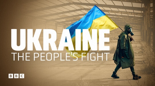 Man in a gas mask carrying the Ukrainian flag